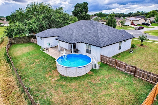 view of pool with a fenced backyard, a yard, a patio area, and a fenced in pool