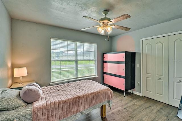 bedroom featuring a closet, ceiling fan, and wood finished floors