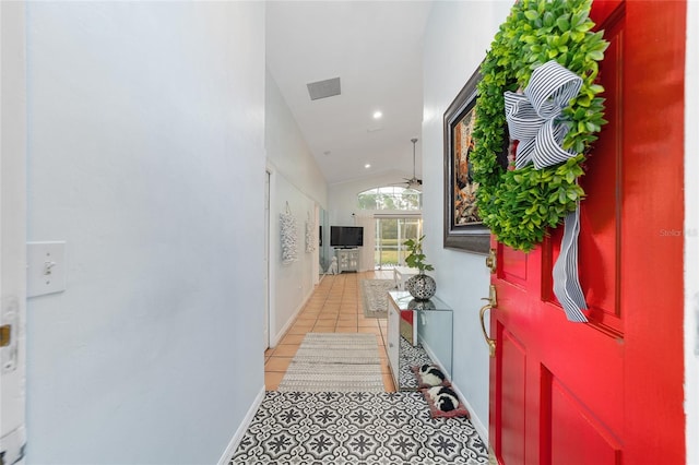 interior space featuring visible vents, baseboards, lofted ceiling, recessed lighting, and light tile patterned flooring