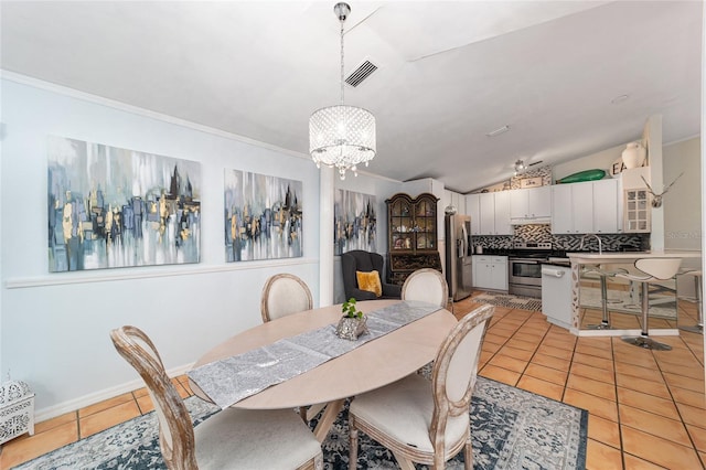 tiled dining space with lofted ceiling, a chandelier, crown molding, and sink