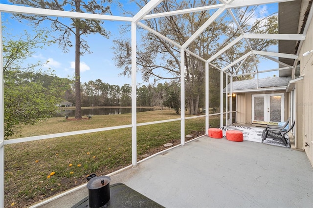 unfurnished sunroom featuring a water view