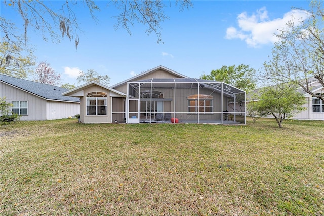 back of property with glass enclosure and a lawn