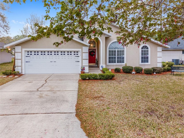 ranch-style house with a garage, a front lawn, and central AC