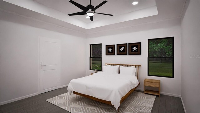 bedroom with a tray ceiling, ceiling fan, and dark hardwood / wood-style flooring