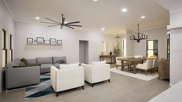 living room with crown molding, ceiling fan with notable chandelier, and hardwood / wood-style flooring