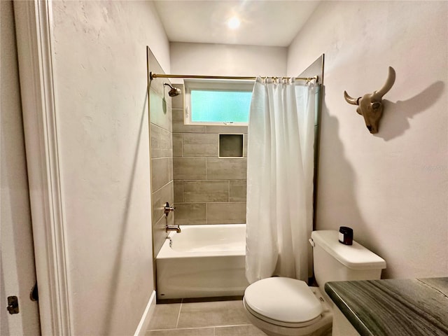 bathroom featuring toilet, tile patterned floors, and shower / tub combo