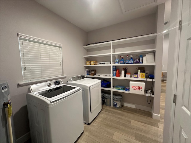 washroom featuring light hardwood / wood-style flooring and washing machine and clothes dryer