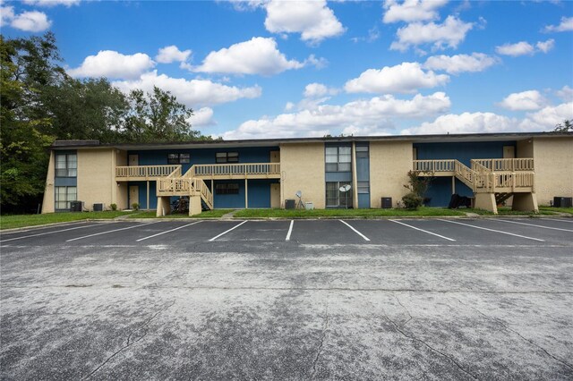 view of property featuring uncovered parking