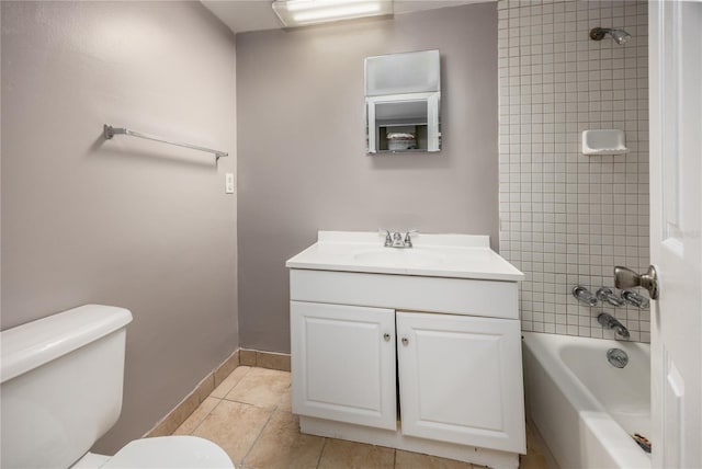 bathroom featuring vanity, washtub / shower combination, baseboards, tile patterned flooring, and toilet