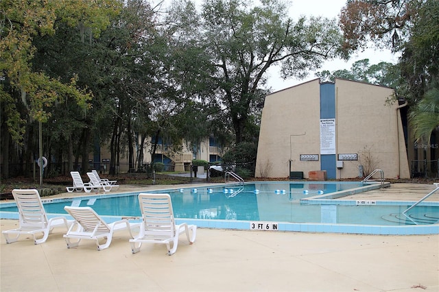 pool featuring a patio and fence