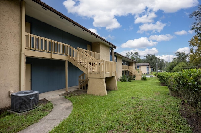 view of yard featuring a deck and central air condition unit