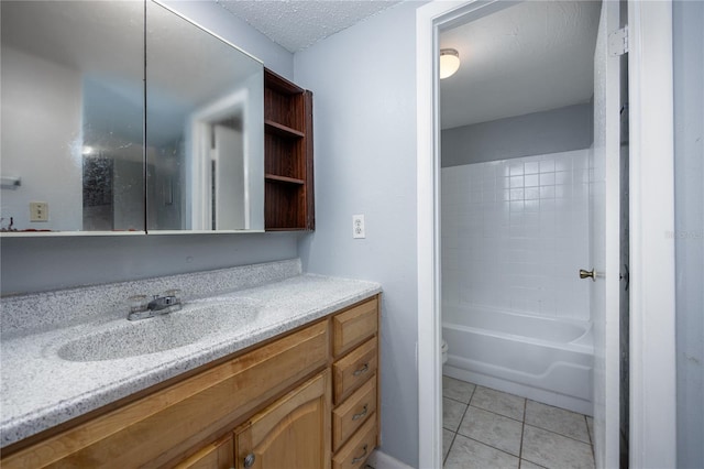 full bathroom with tile patterned flooring, toilet,  shower combination, vanity, and a textured ceiling