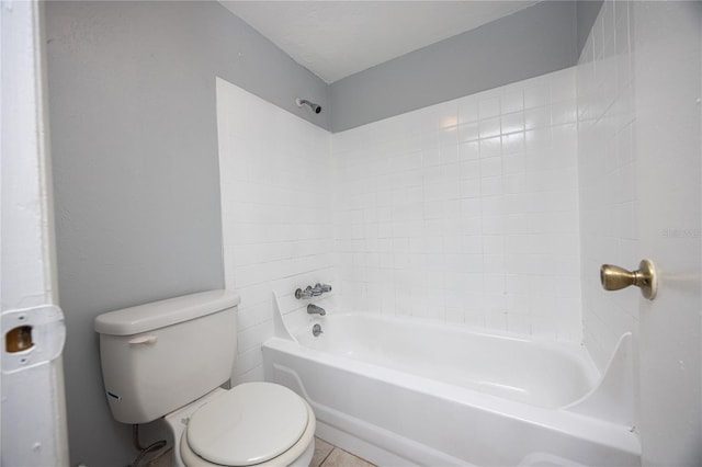 bathroom with tile patterned flooring, toilet, and  shower combination