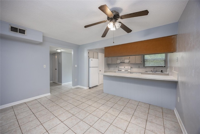 kitchen with visible vents, light countertops, a peninsula, exhaust hood, and white appliances