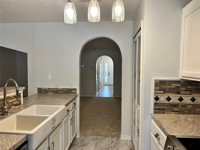 kitchen with light carpet, pendant lighting, decorative backsplash, and white cabinetry