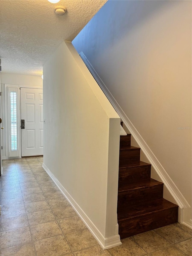 interior space with a textured ceiling