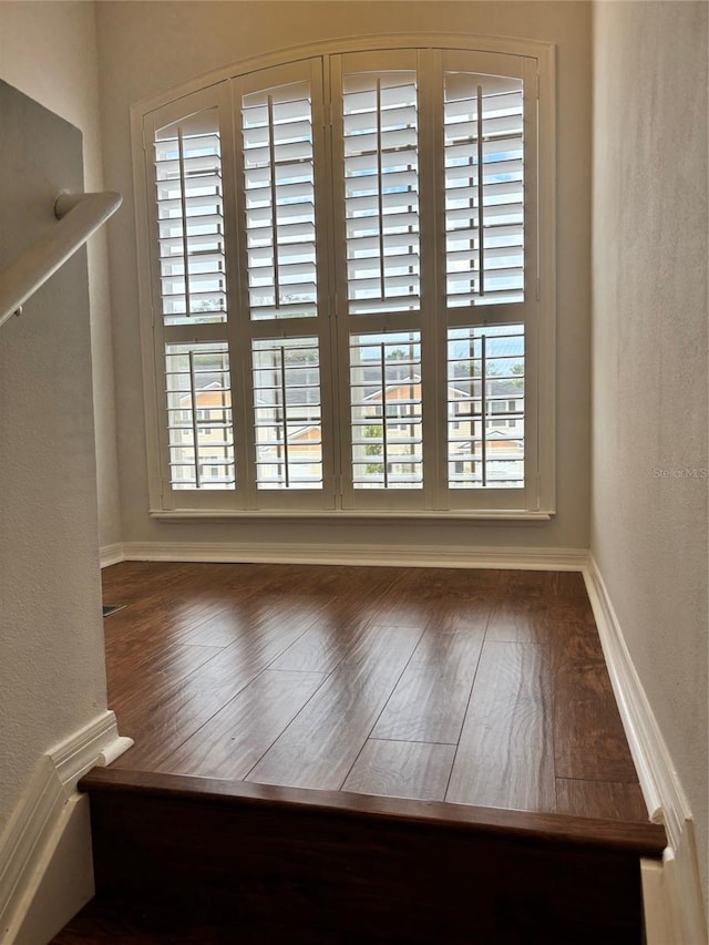 spare room with hardwood / wood-style flooring and a healthy amount of sunlight