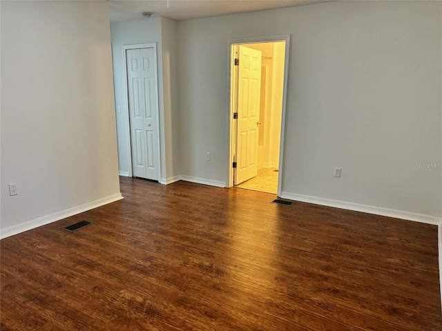 empty room featuring dark hardwood / wood-style floors