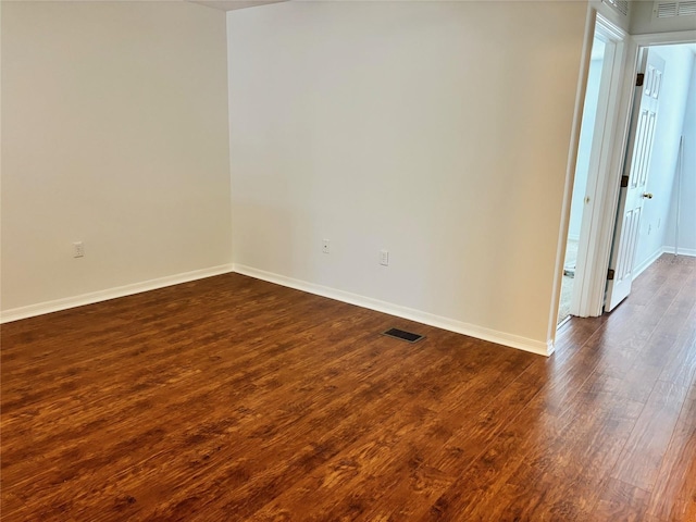 spare room featuring dark hardwood / wood-style flooring