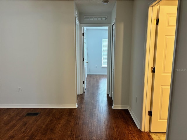 hallway with hardwood / wood-style flooring