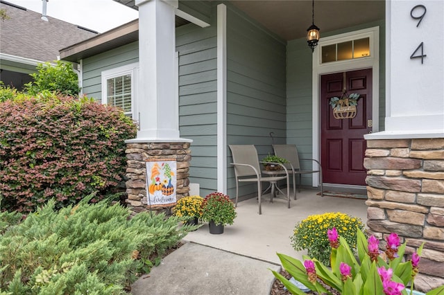 view of exterior entry with a porch