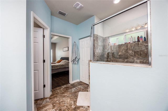 bathroom featuring a shower with door