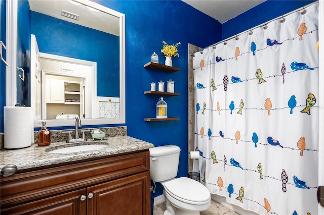 bathroom with vanity, toilet, a shower with curtain, and tile patterned floors