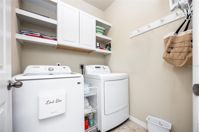 washroom featuring cabinets and separate washer and dryer