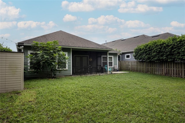 back of house with a lawn