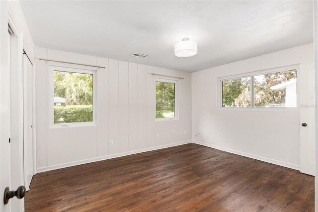 spare room featuring dark wood-type flooring