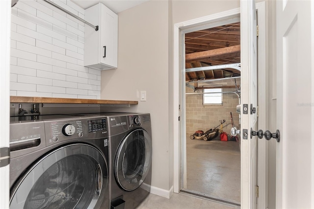 laundry room featuring cabinets and washing machine and dryer