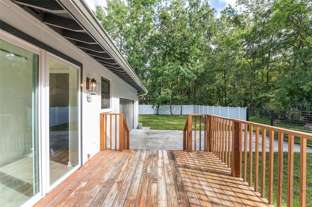 wooden terrace featuring a yard