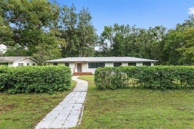 ranch-style home featuring a front yard