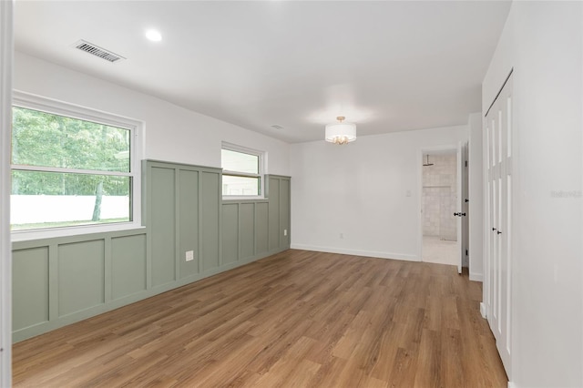 spare room with light hardwood / wood-style floors