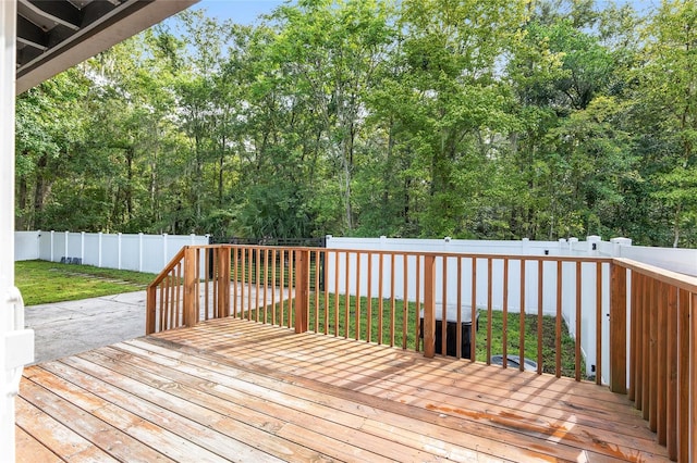 wooden terrace featuring a yard