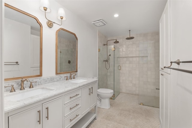 bathroom with vanity, toilet, and a shower with shower door