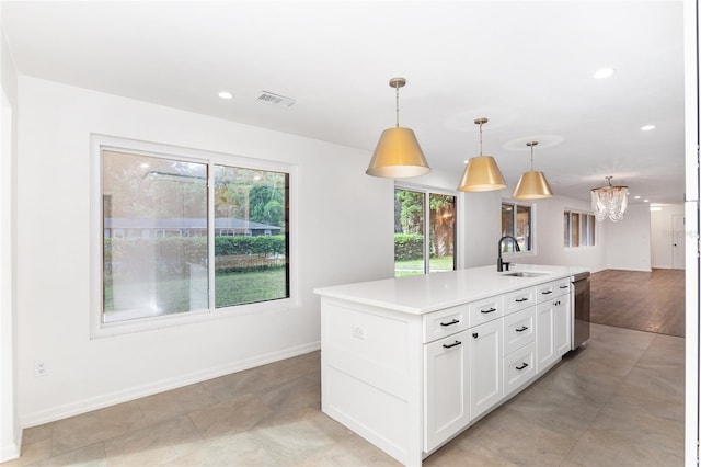 kitchen with dishwasher, sink, pendant lighting, a center island with sink, and white cabinets