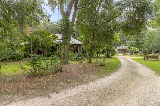 obstructed view of property featuring a front lawn