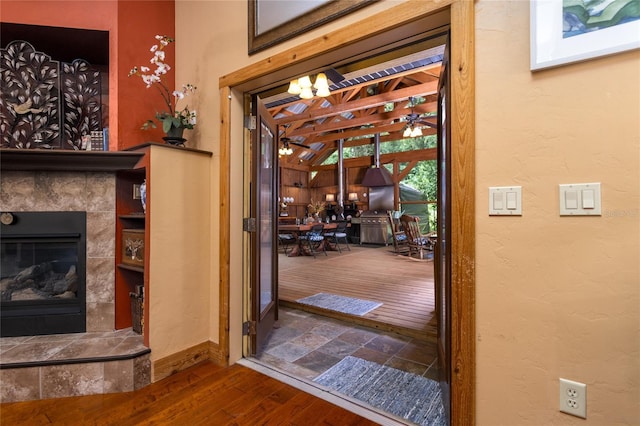 interior space with hardwood / wood-style flooring and a tile fireplace