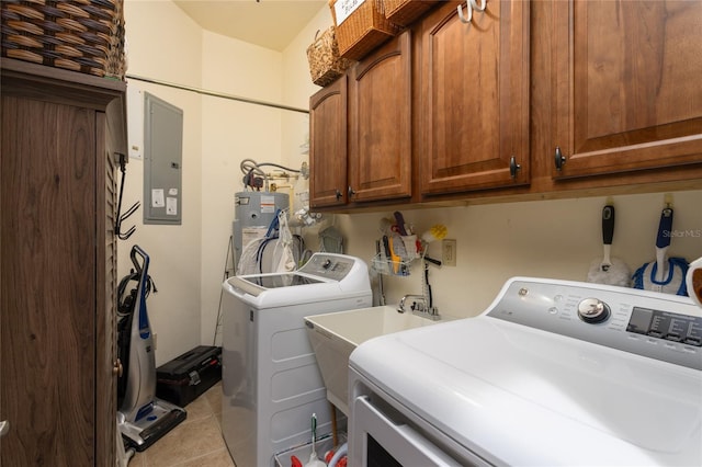 laundry room with light tile patterned floors, washer and dryer, electric panel, cabinets, and water heater