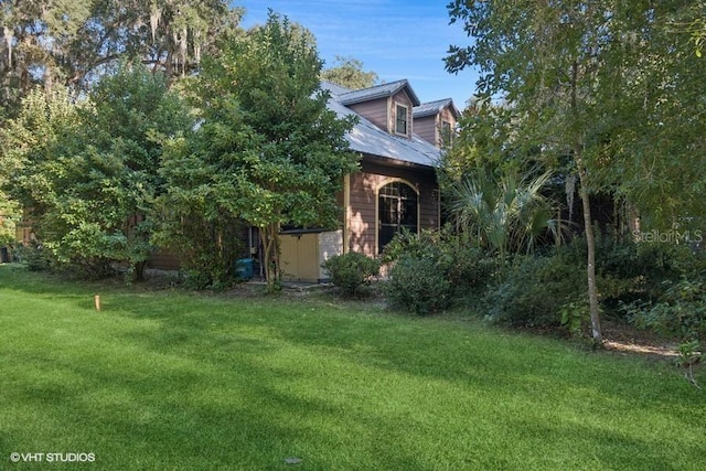 view of side of home with a lawn