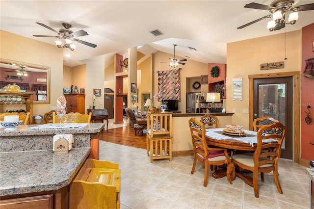 dining room featuring light tile patterned flooring, ceiling fan, and vaulted ceiling