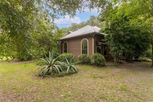 view of home's exterior with a yard