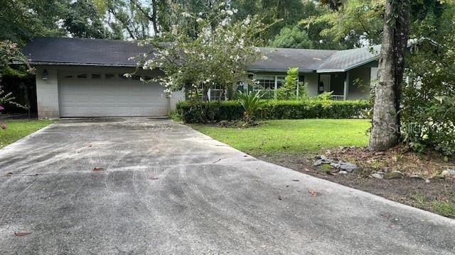 ranch-style home with a front yard and a garage