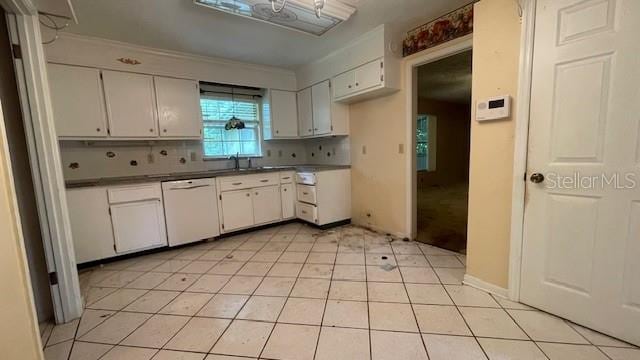 kitchen featuring white cabinets, backsplash, dishwasher, and light tile patterned floors