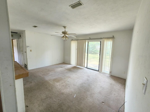 spare room featuring ceiling fan and light carpet