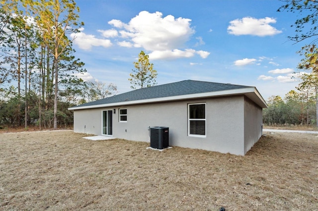 back of house featuring central air condition unit