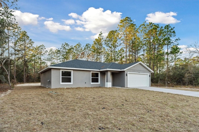 single story home featuring a front lawn and a garage