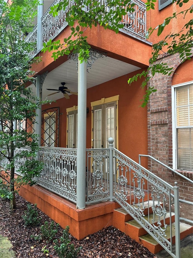 exterior space with a balcony and ceiling fan