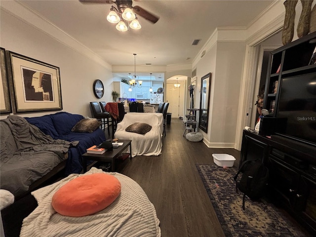 living room with ceiling fan with notable chandelier, crown molding, and dark wood-type flooring